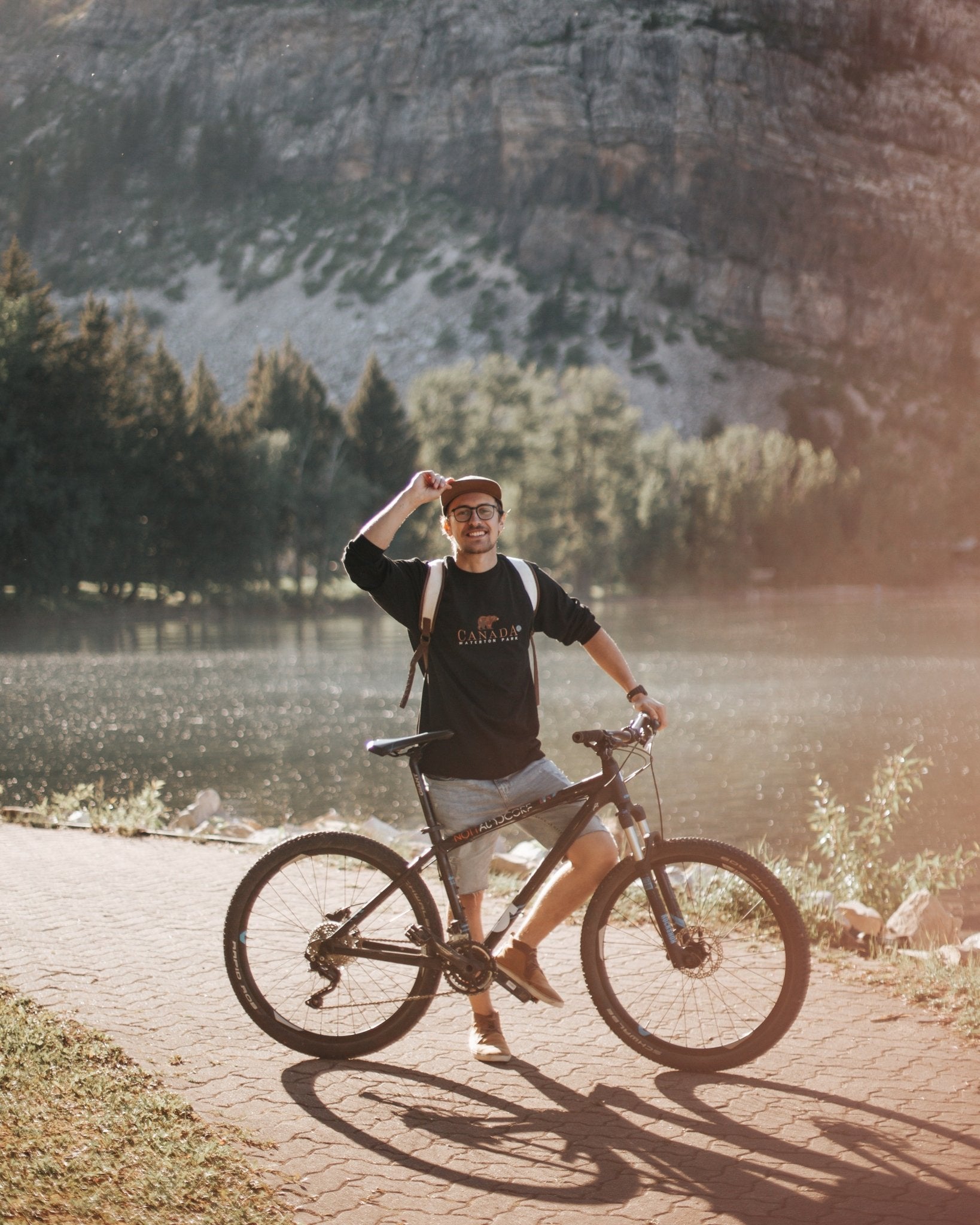 a mountain biker standing behind his bike