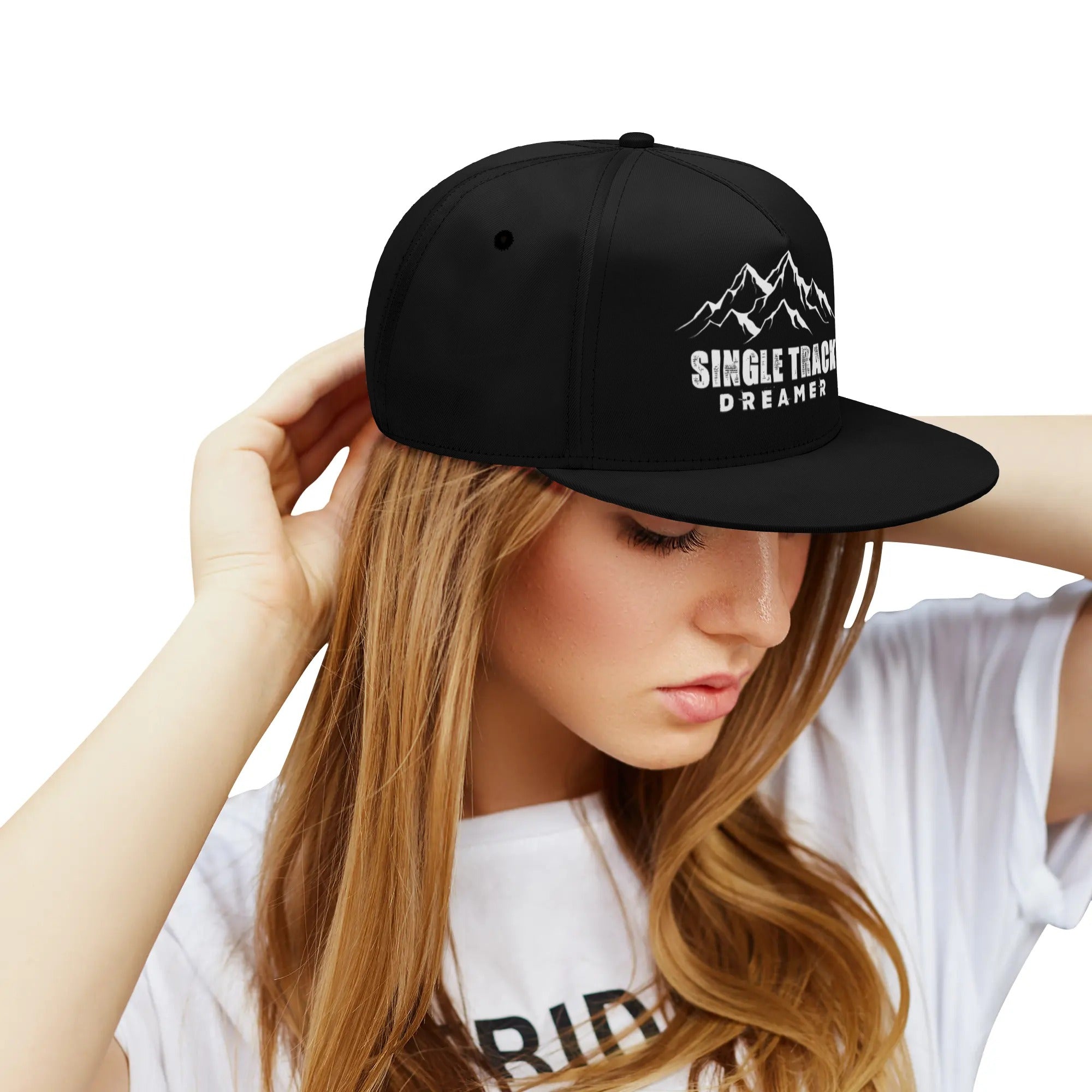 a young woman wearing a black hat with a mountain scene on it