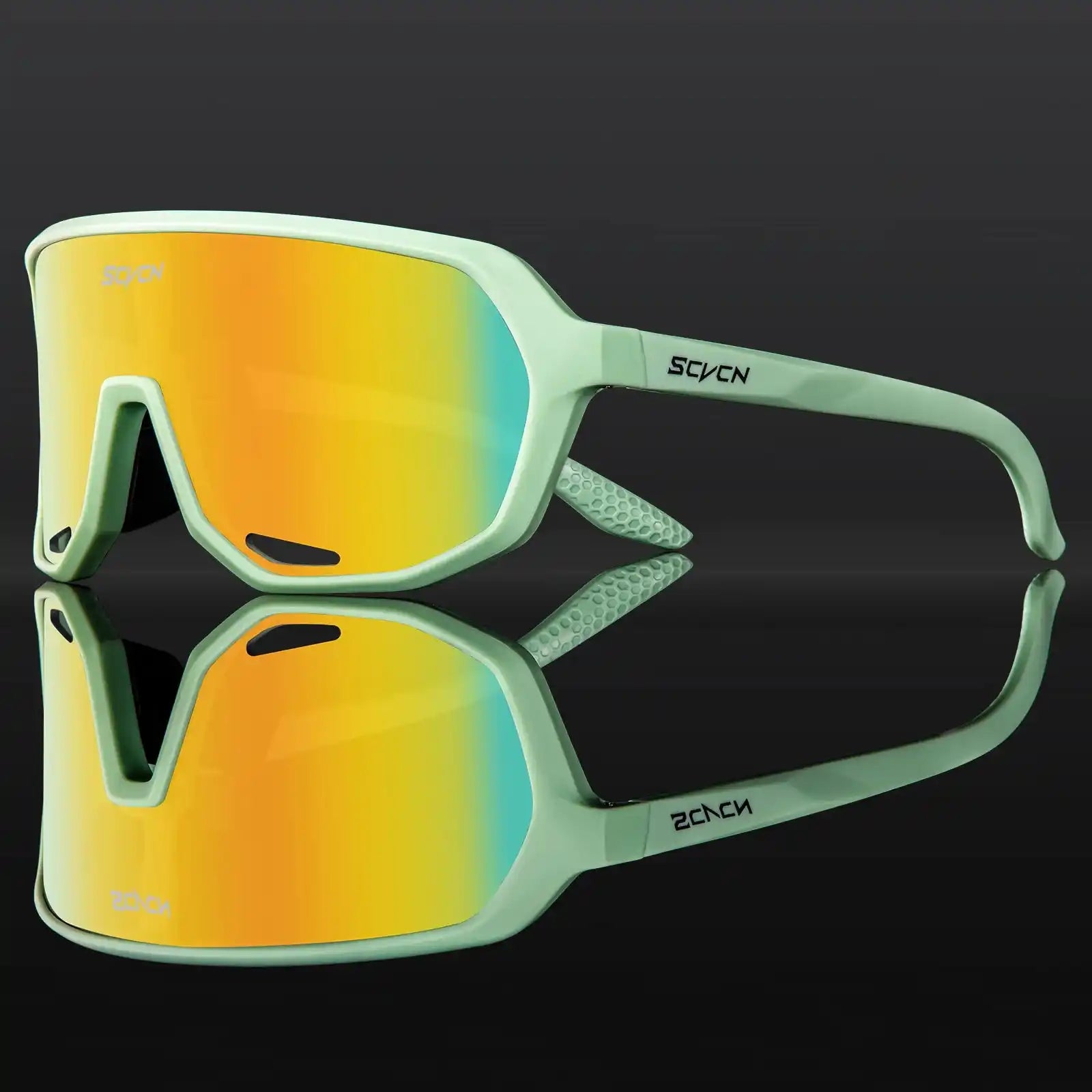 Mint green cycling sunglasses with yellow-orange photochromic lenses, designed for UV protection and lightweight sports performance.