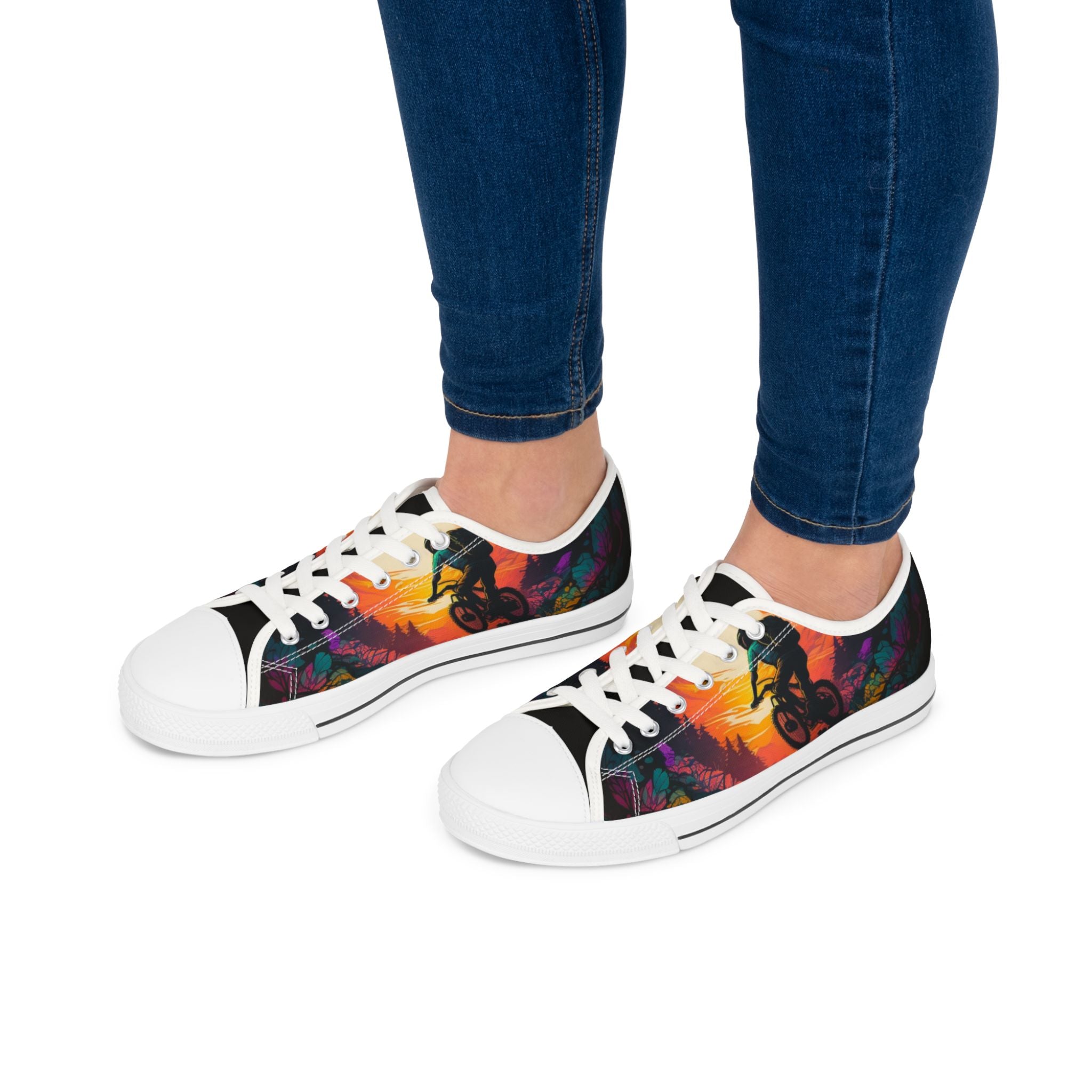 Women wearing MTB Sunset Sneakers with white soles, styled with jeans, showcasing colorful biking-themed footwear for outdoor lovers.
