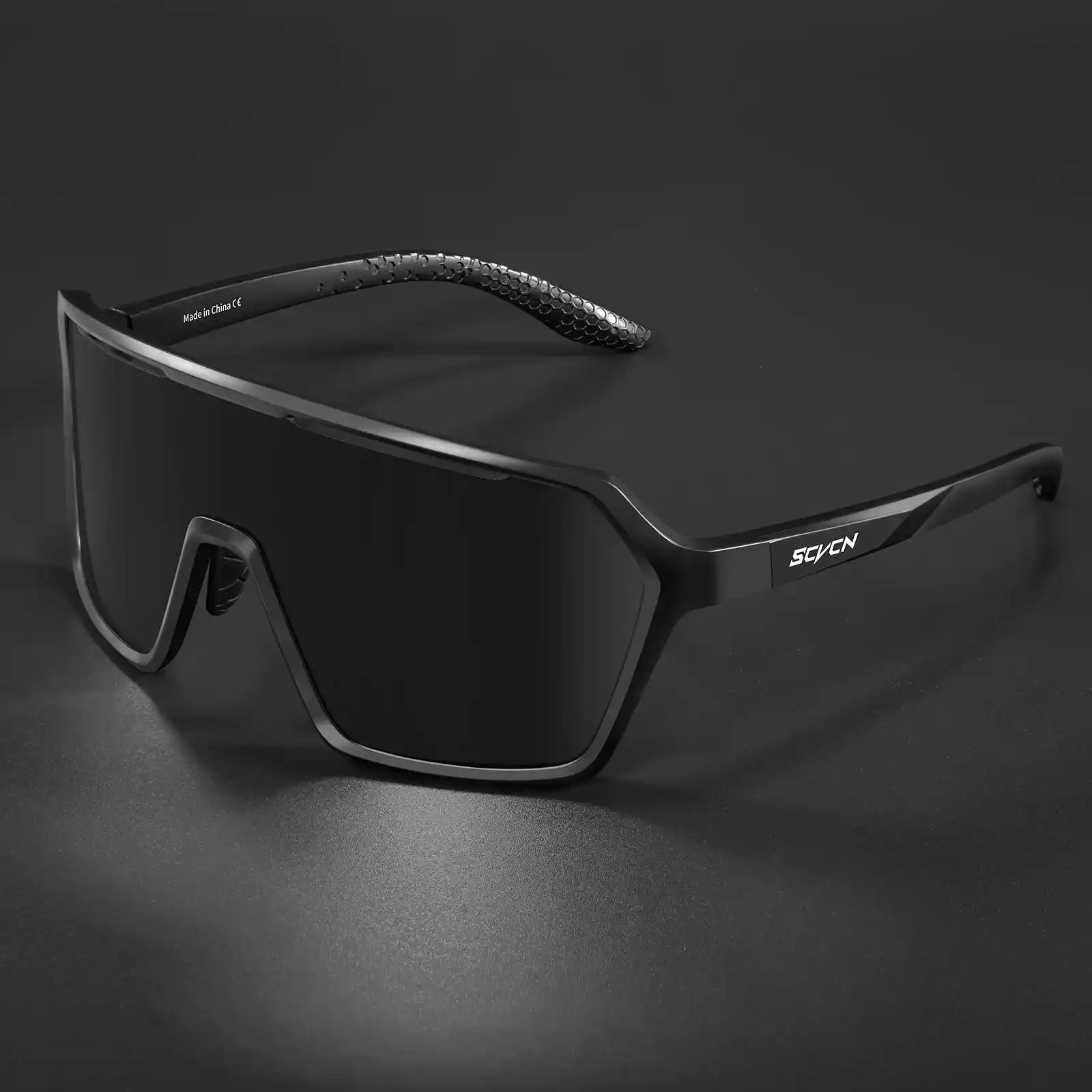 Black photochromic cycling sunglasses with fully darkened lenses, offering UV400 protection for intense sunlight conditions.