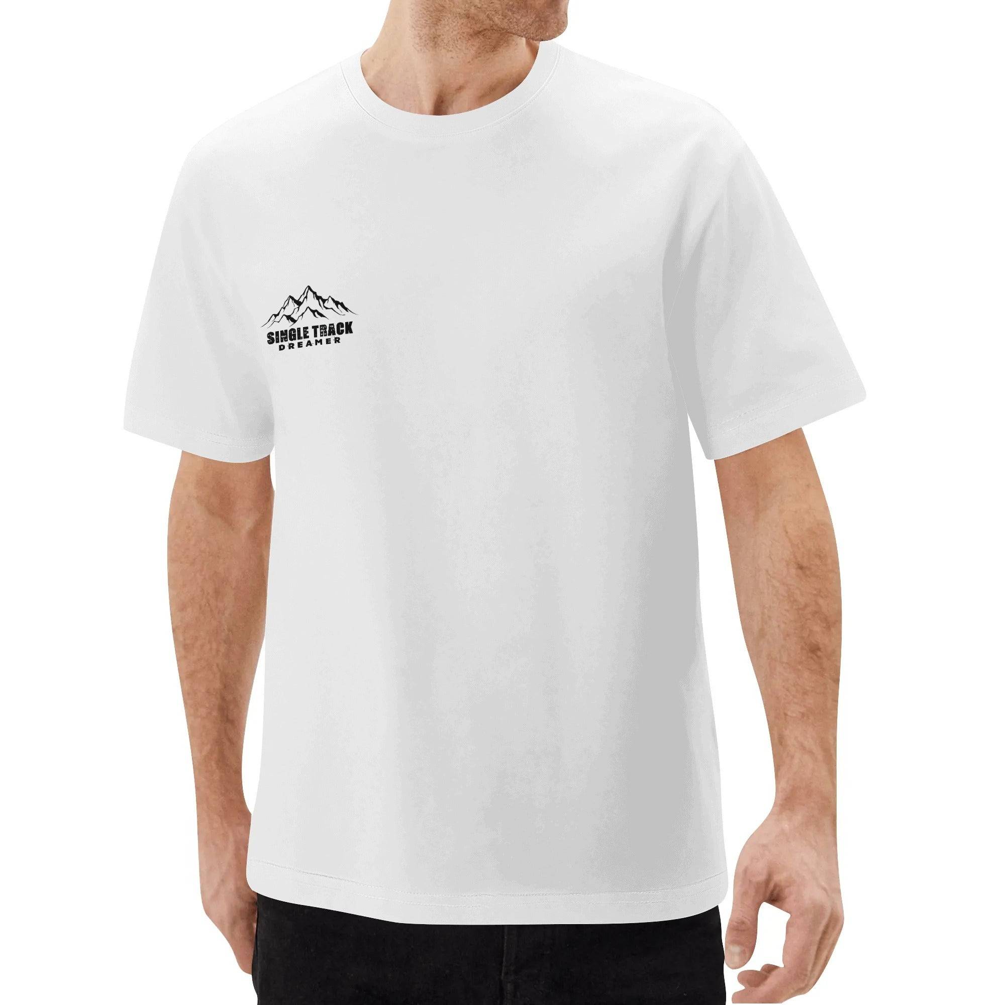 a man wearing a white t - shirt with mountains on it