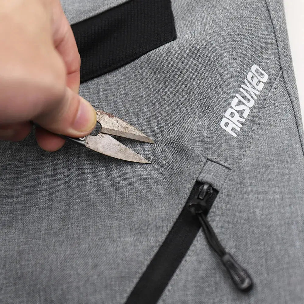 a person cutting a piece of fabric with a pair of scissors