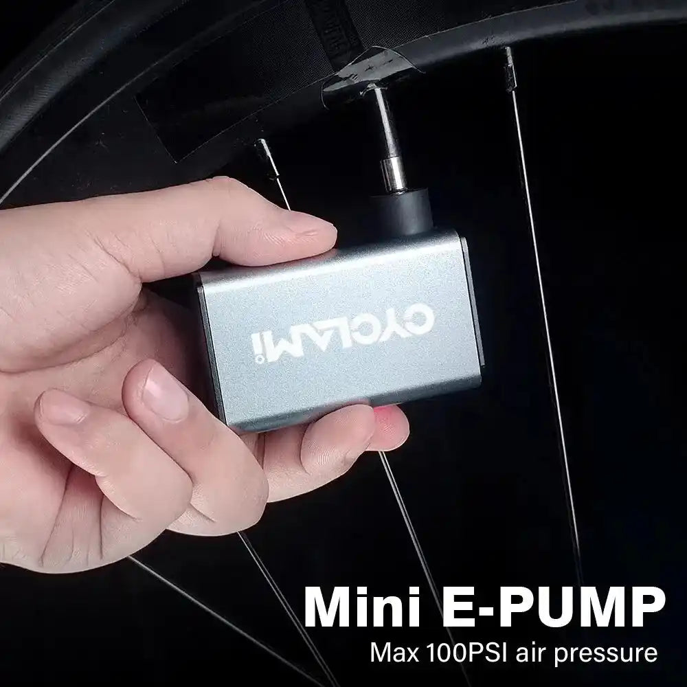 CYCLAMI A3 mini electric air pump inflating a bicycle tire with Presta valve, compact cordless design for easy use on the go.