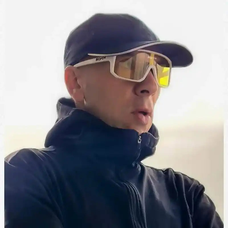 Man wearing SCVCN white polarized cycling sunglasses with yellow lenses, ideal for outdoor sports and UV400 eye protection.