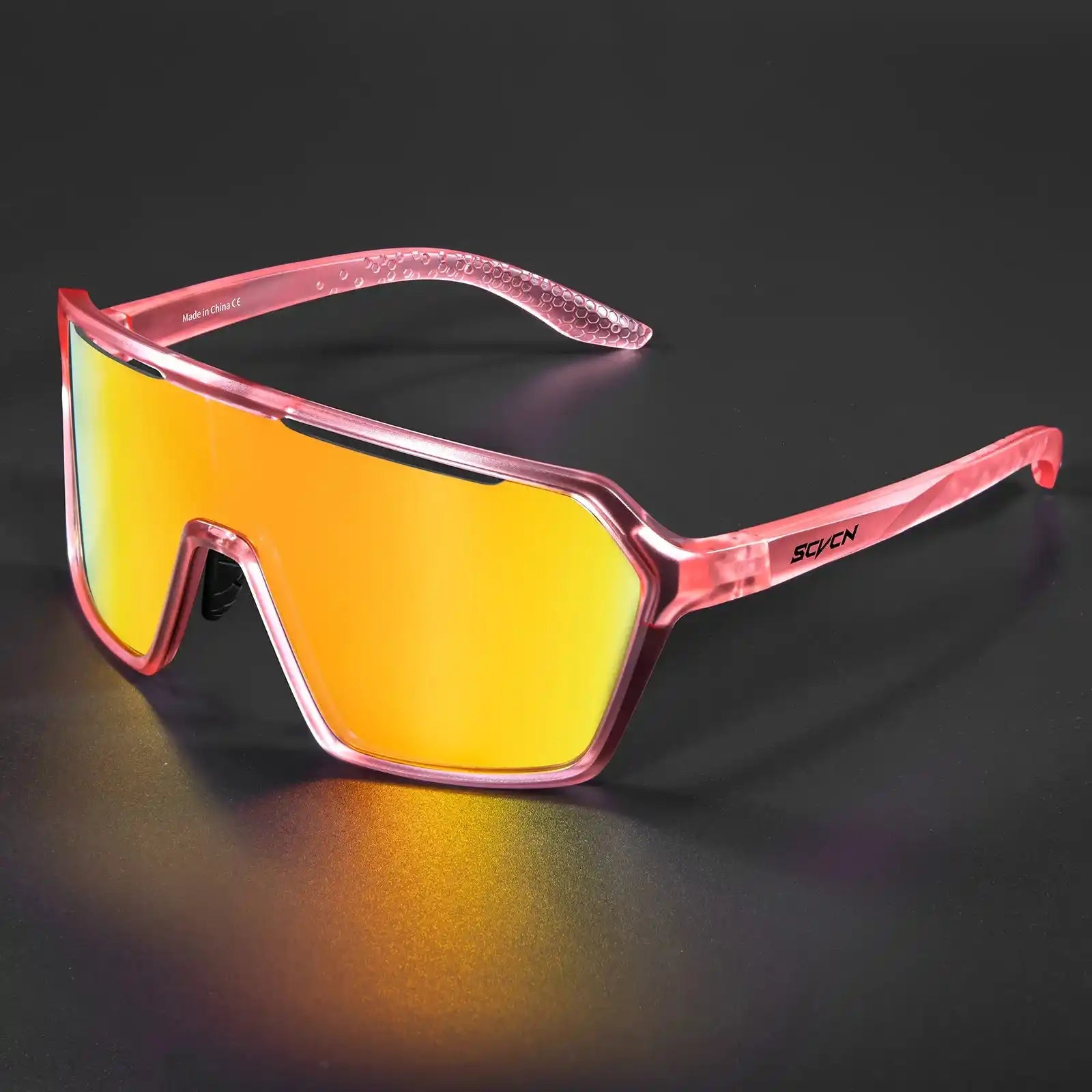 Pink photochromic cycling sunglasses with orange mirrored UV400 lenses, ideal for outdoor sports in bright conditions.